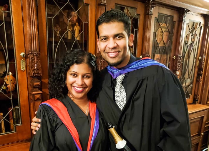 Man and a woman in graduation gowns